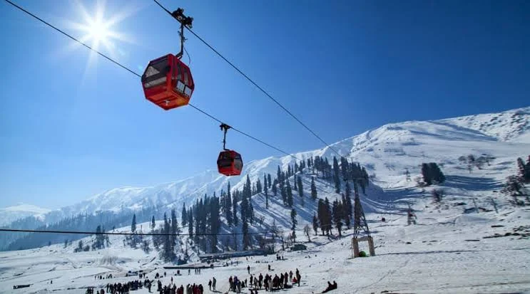 Gulmarg Ski Resort in India - a group of people standing on top of a ski slope.