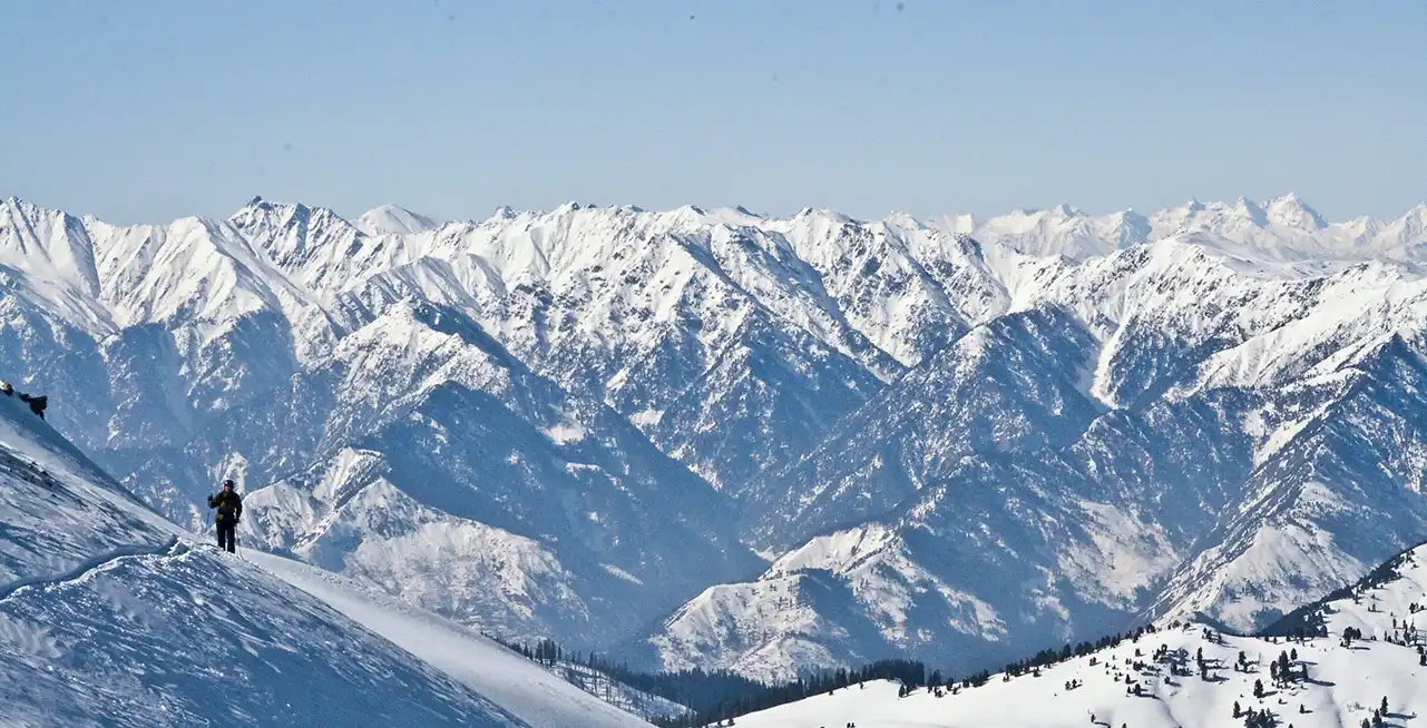 Gulmarg Ski Resort in India - a view of snow covered mountains from a ski slope.