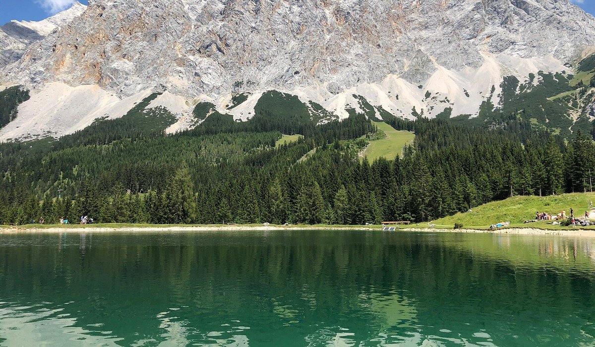 Ehrwalder Wettersteinbahnen in Austria - a lake with a mountain in the background.