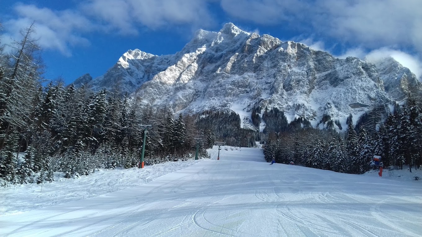 Ehrwalder Wettersteinbahnen in Austria - a snow covered ski slope with a mountain in the background.