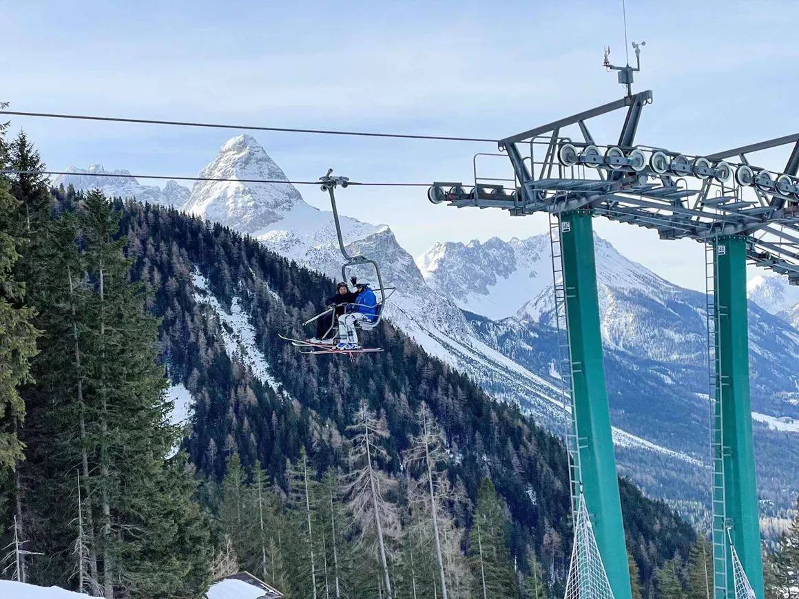Ehrwalder Wettersteinbahnen in Austria - a person riding a ski lift in the mountains.