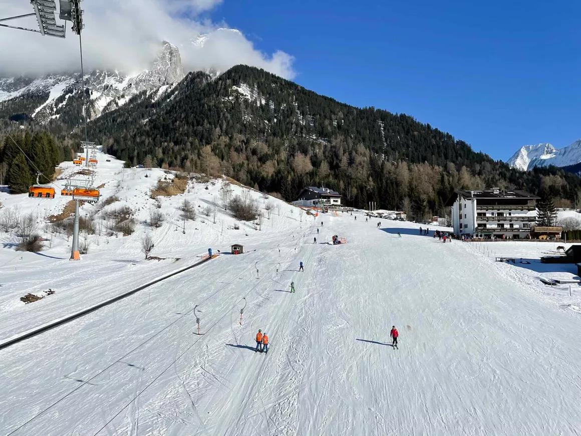 Ehrwalder Wettersteinbahnen in Austria - a ski slope with people skiing down it.