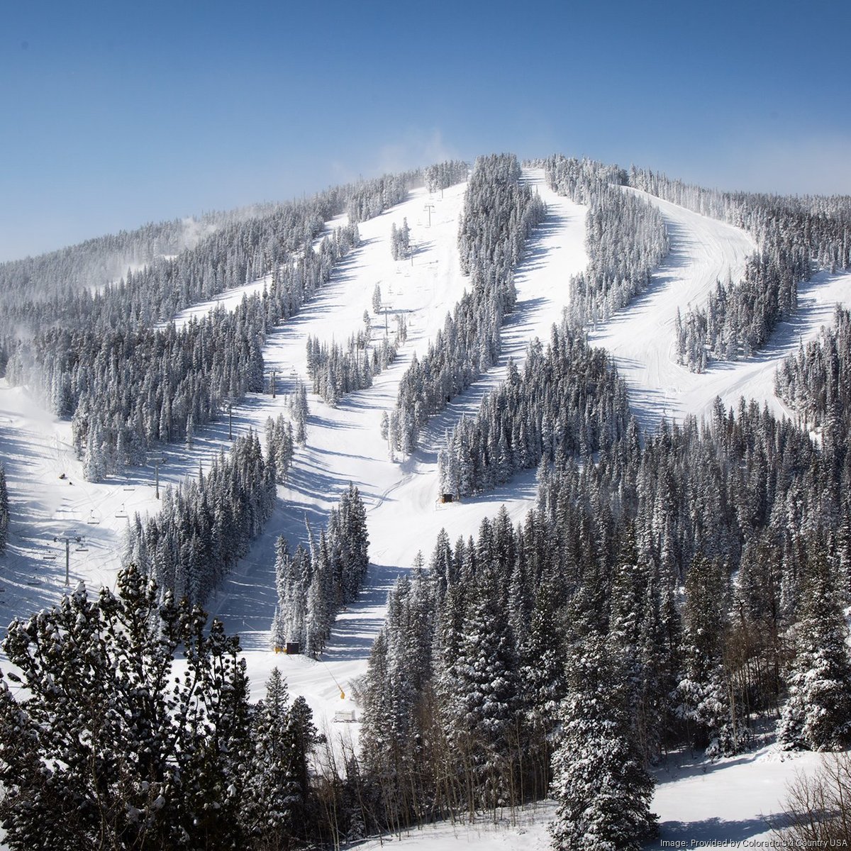 Eldora Mountain in USA - a snowy mountain covered in snow and trees.