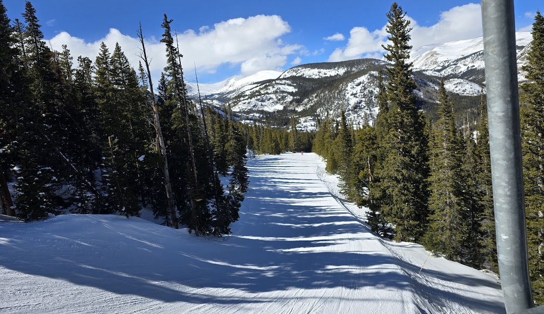 Eldora Mountain in USA - a ski slope with trees and snow on it.