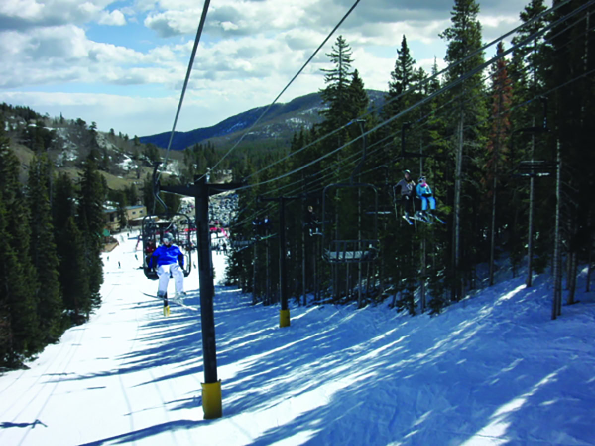 Eldora Mountain in USA - a group of people skiing down a ski slope.