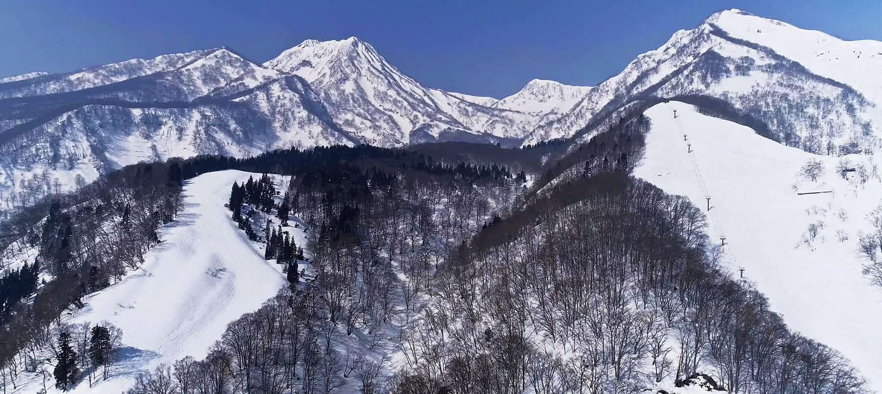Seki Onsen in Japan - snow covered mountains on a sunny day.
