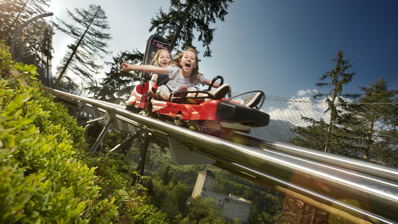Hochstein – Lienz in Austria - a little girl riding on a ride at a theme park.