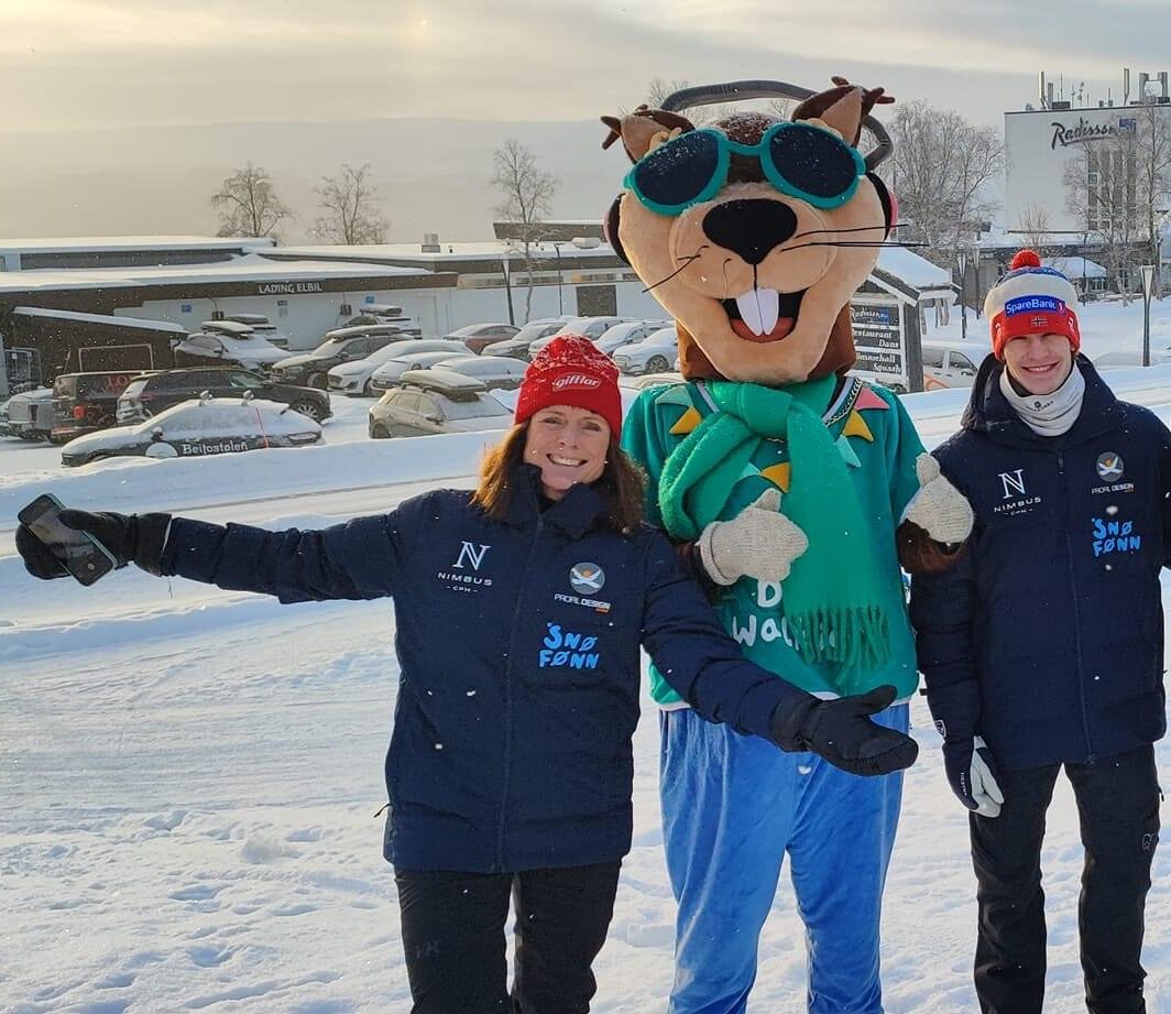 Winter sports scene at Beitostølen in Valdres, Oppland, Norway, featuring a skier and a chalet, with a family enjoying a day of skiing at the bustling winter sports centre.