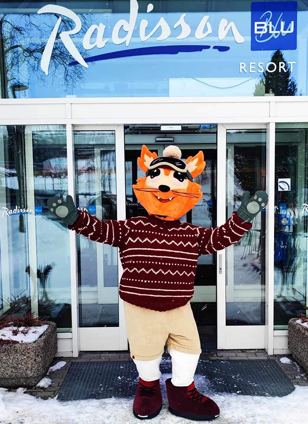 A skier enjoying a sunny day at the Beitostølen ski resort in Valdres, Oppland, Norway, with a charming challet in the background. The perfect winter sports scene brought to life.