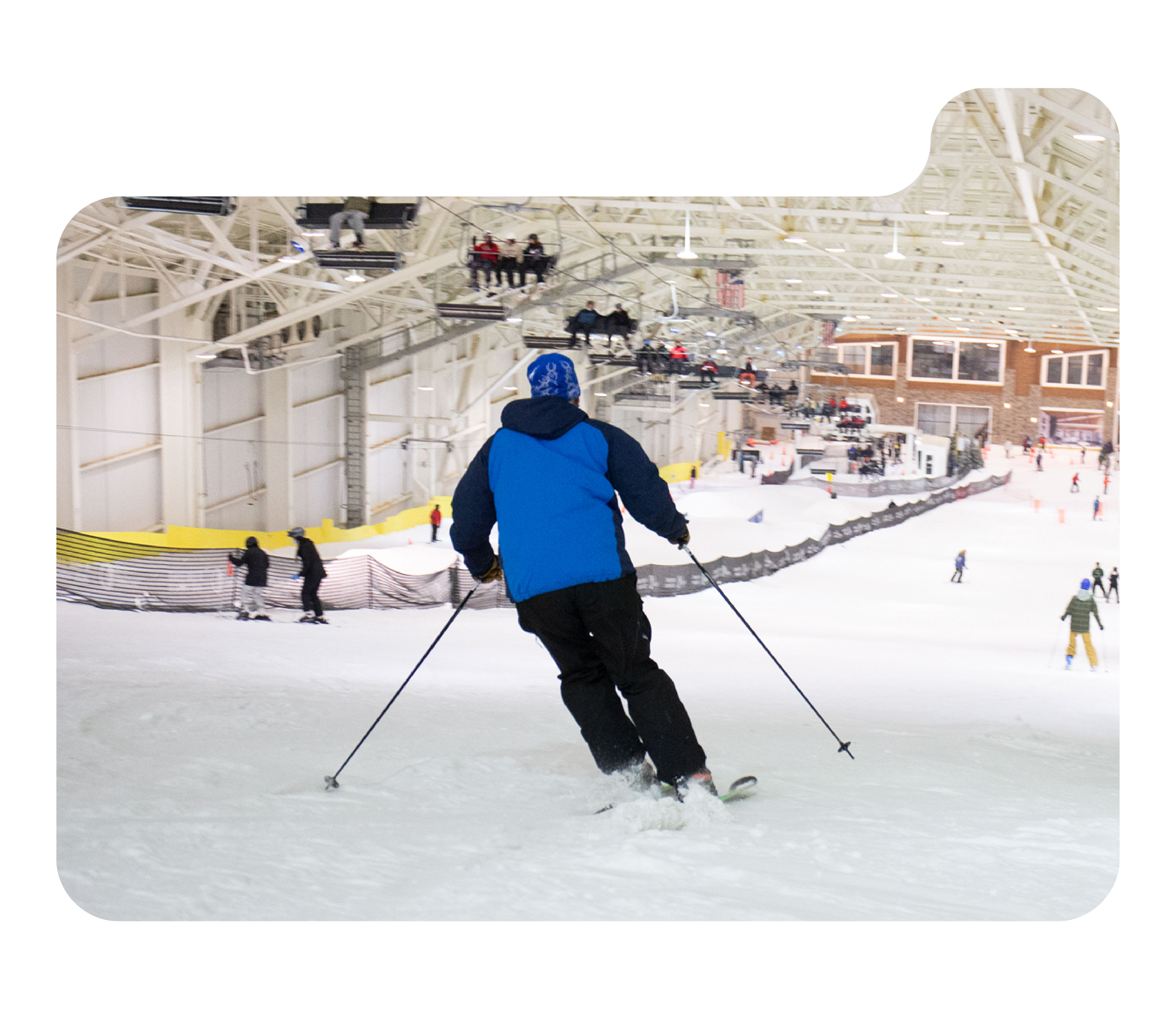 A winter sports scene at Big Snow American Dream in New Jersey, showcasing individuals participating in skiing on the smooth, snow-covered slopes.