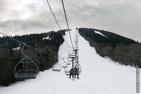 Pico Mountain in USA - a person on a ski lift going down the mountain.