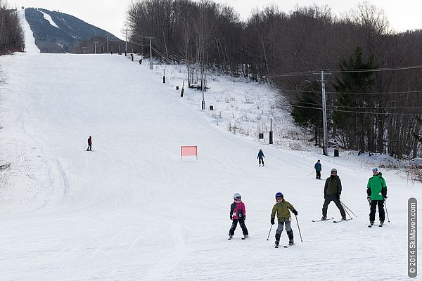 Pico Mountain in USA - a group of people skiing down a snowy slope.