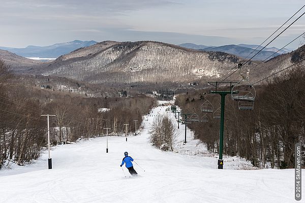 Pico Mountain in USA - a person skiing down a hill with mountains in the background.
