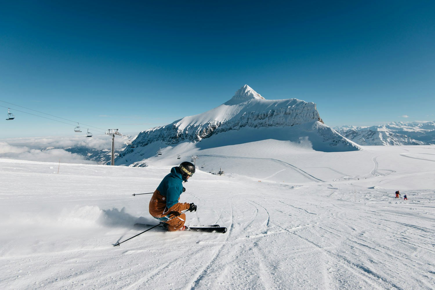 Glacier 3000 – Les Diablerets in Switzerland - a person riding skis down a snowy slope.