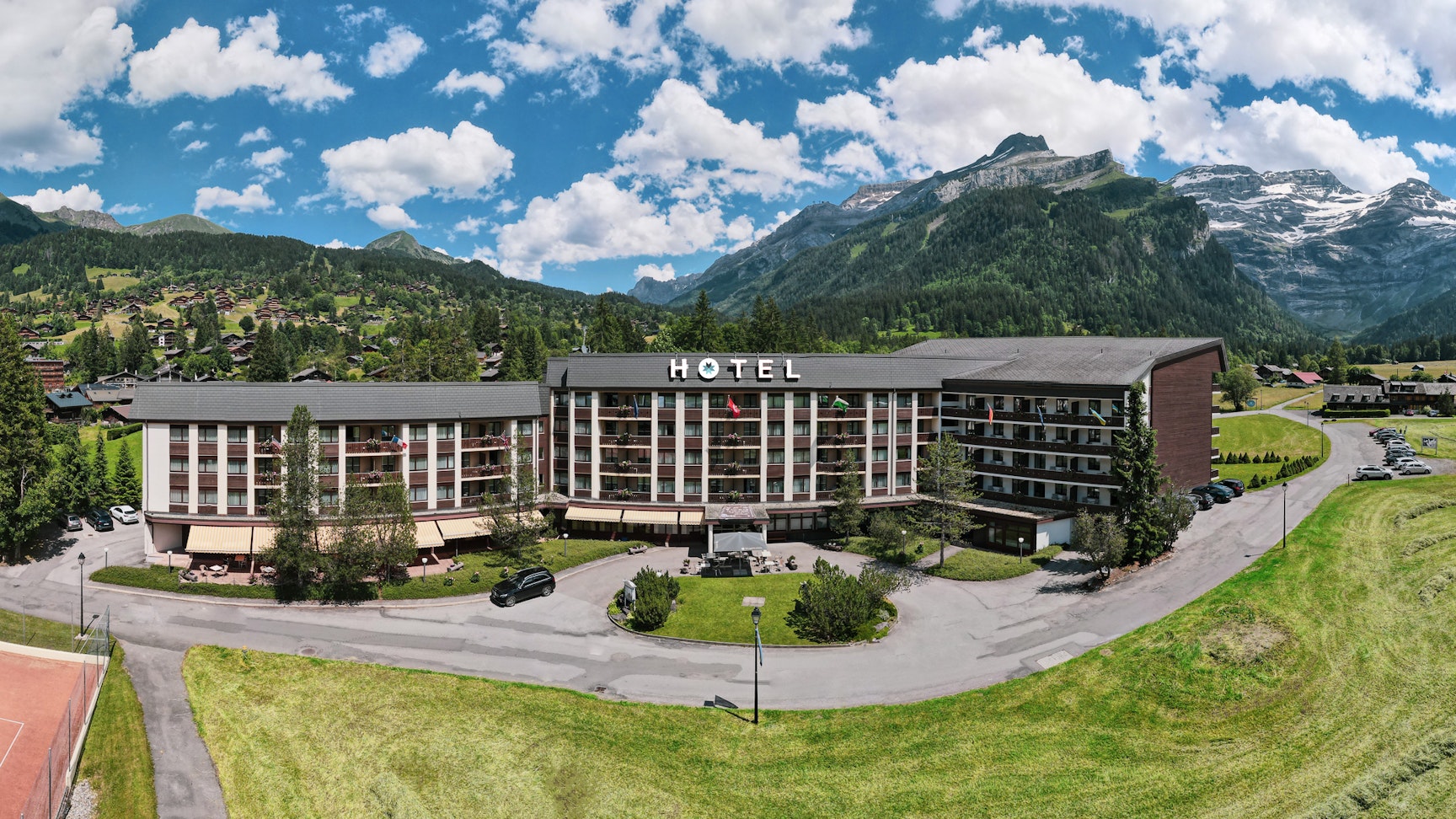 Glacier 3000 – Les Diablerets in Switzerland: a view of a hotel with mountains in the background.