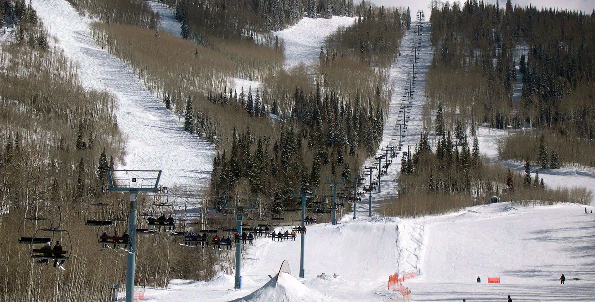 Powderhorn in USA - a group of people skiing down a snowy slope.