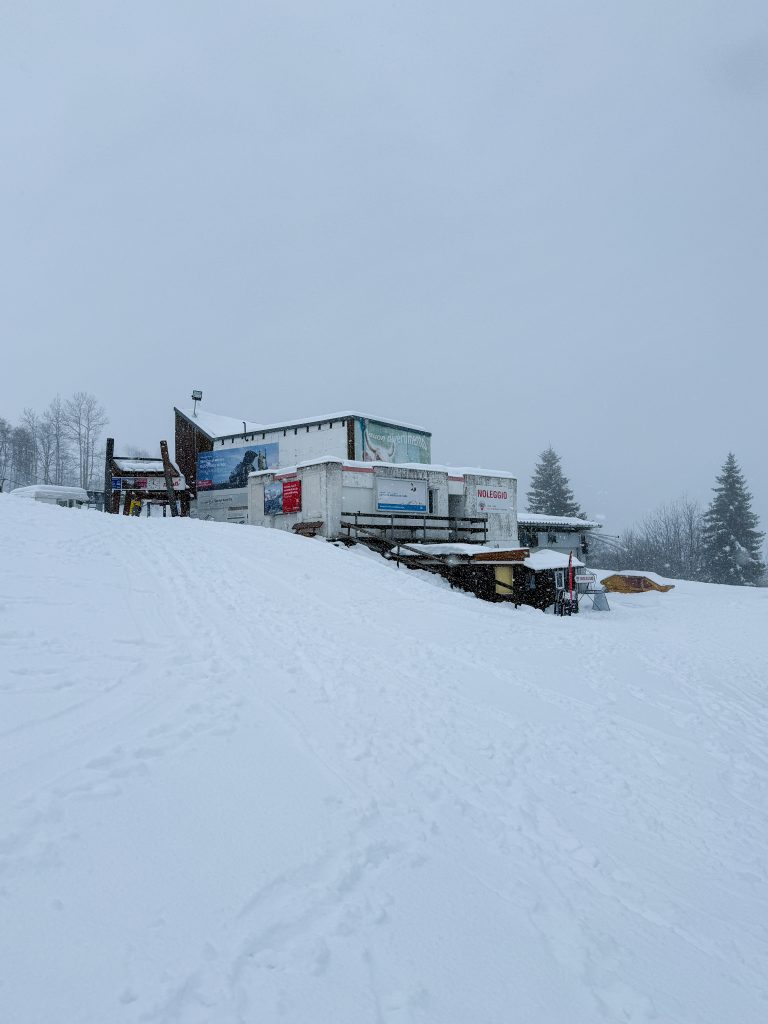 Amici del Nara in Switzerland - a truck parked on top of a snow covered hill.
