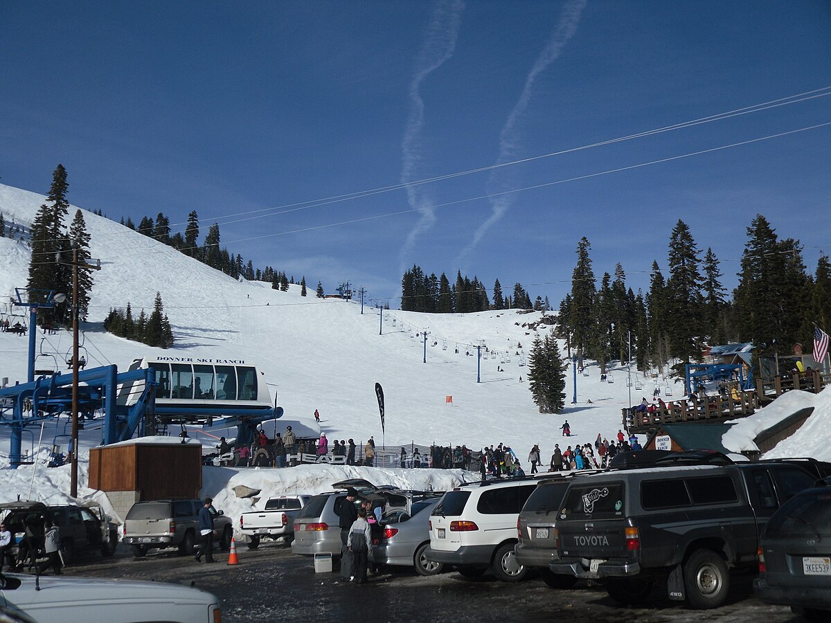 Donner Ski Ranch in USA - a group of cars parked on a snowy slope.