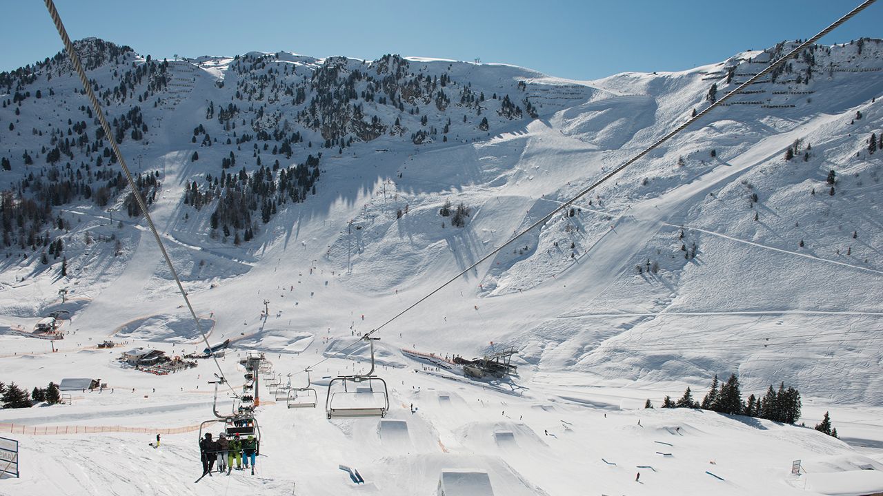 Mayrhofen Penken | Ahorn | Rastkogel | Eggalm in Austria - a group of people riding ski boards on a snowy slope.