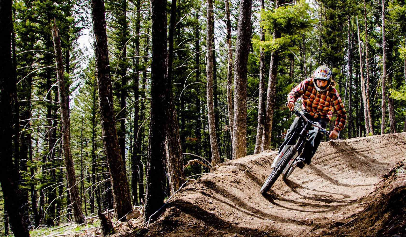 Discovery Ski Area in USA - a person riding on a dirt bike in the woods.