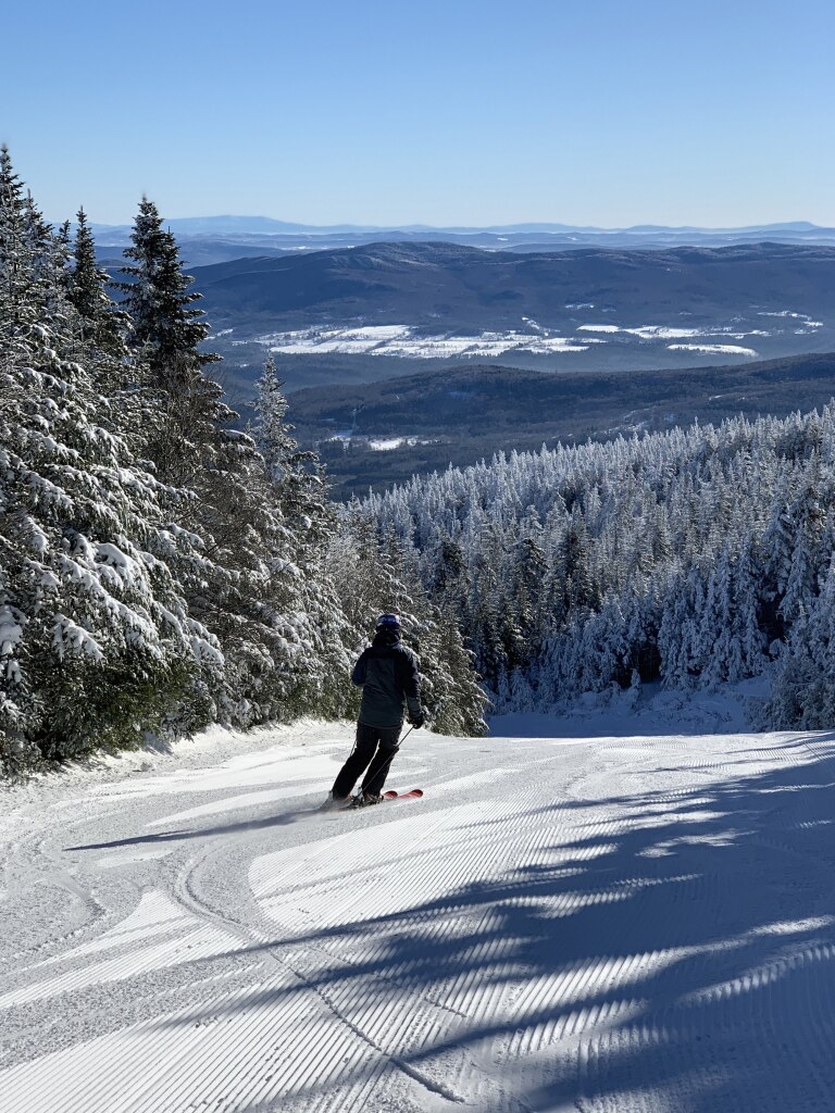 Mad River Glen in USA - a person on a snowboard going down a hill.