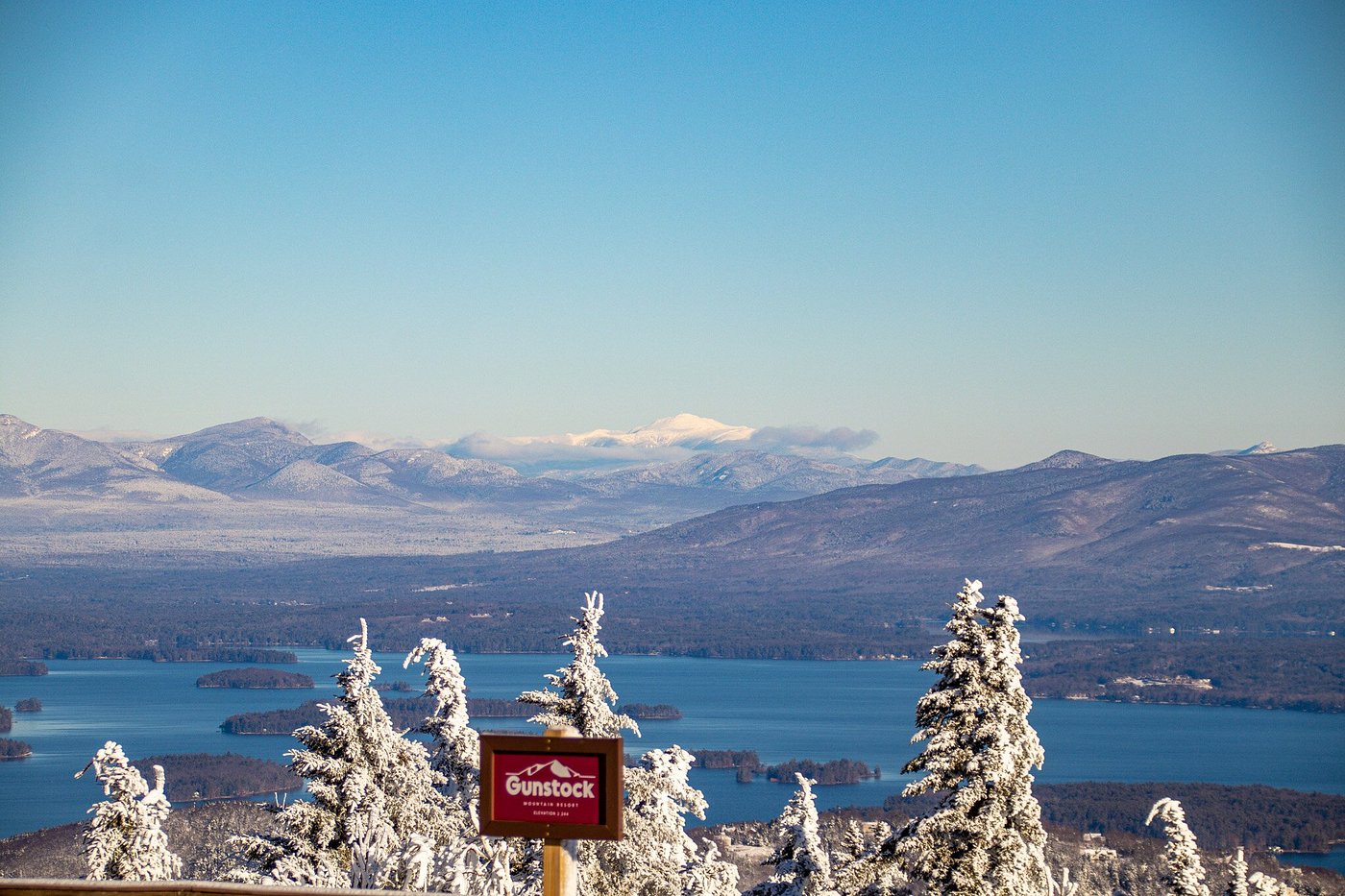 Gunstock Mountain Resort in USA - the view from the top of a mountain with snow covered trees.