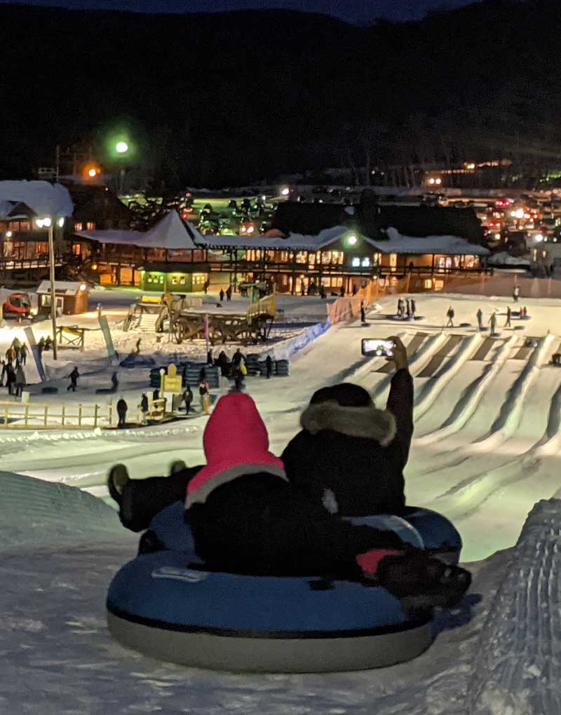 Gunstock Mountain Resort in USA - a person on a snowboard in the snow.