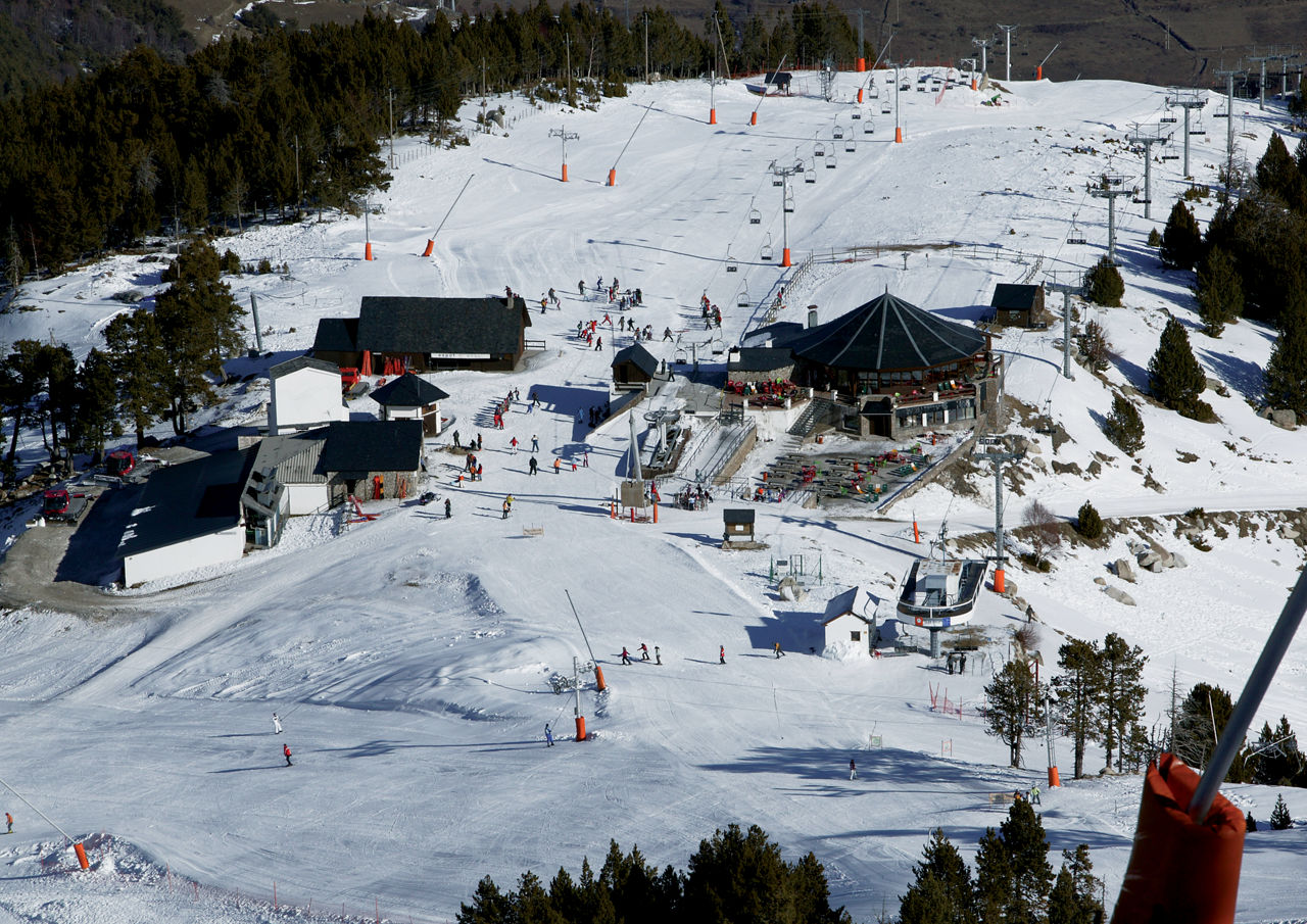 Espot Esqui in Spain - a group of people skiing down a snowy hill.