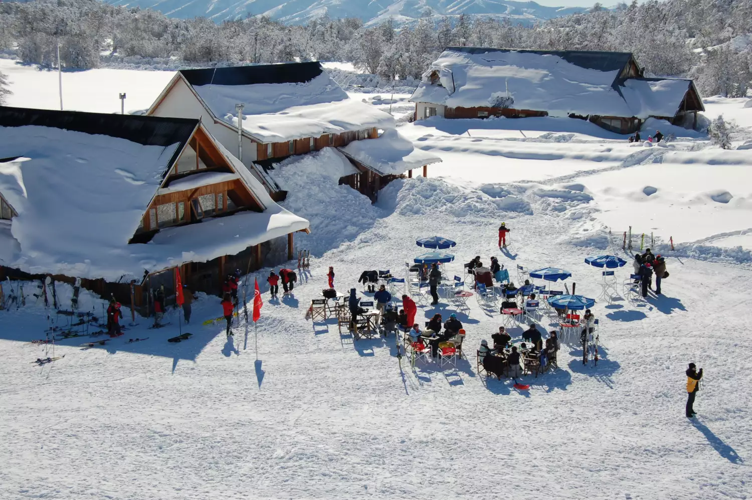 Chapelco in Argentina - a group of people standing on top of a snow covered mountain.