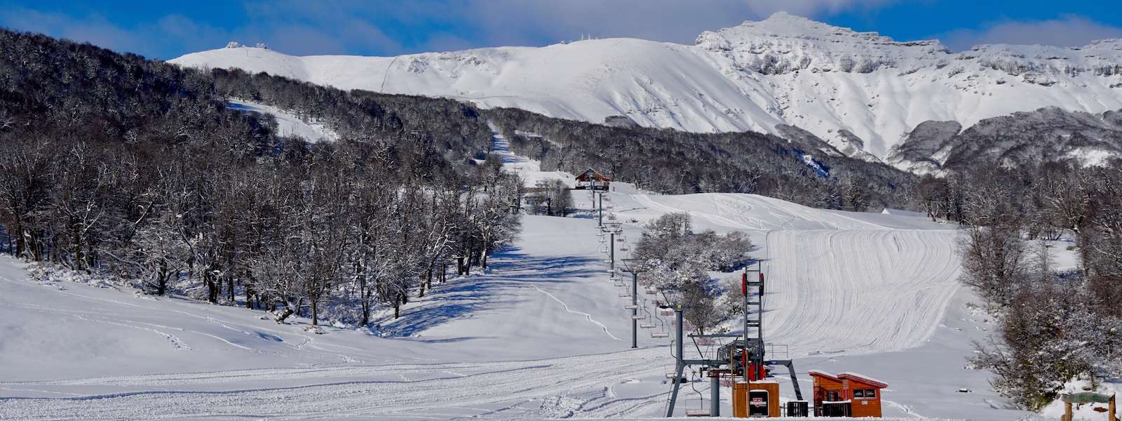 Chapelco in Argentina - a ski slope with snow covered mountains in the background.