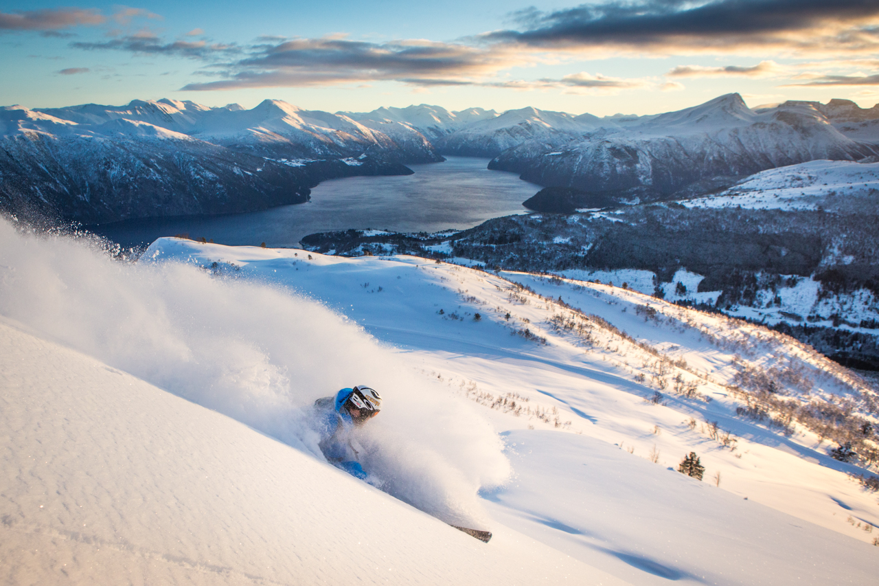 Strandafjellet Skisenter in Norway - a person riding a snowboard down a snowy slope.