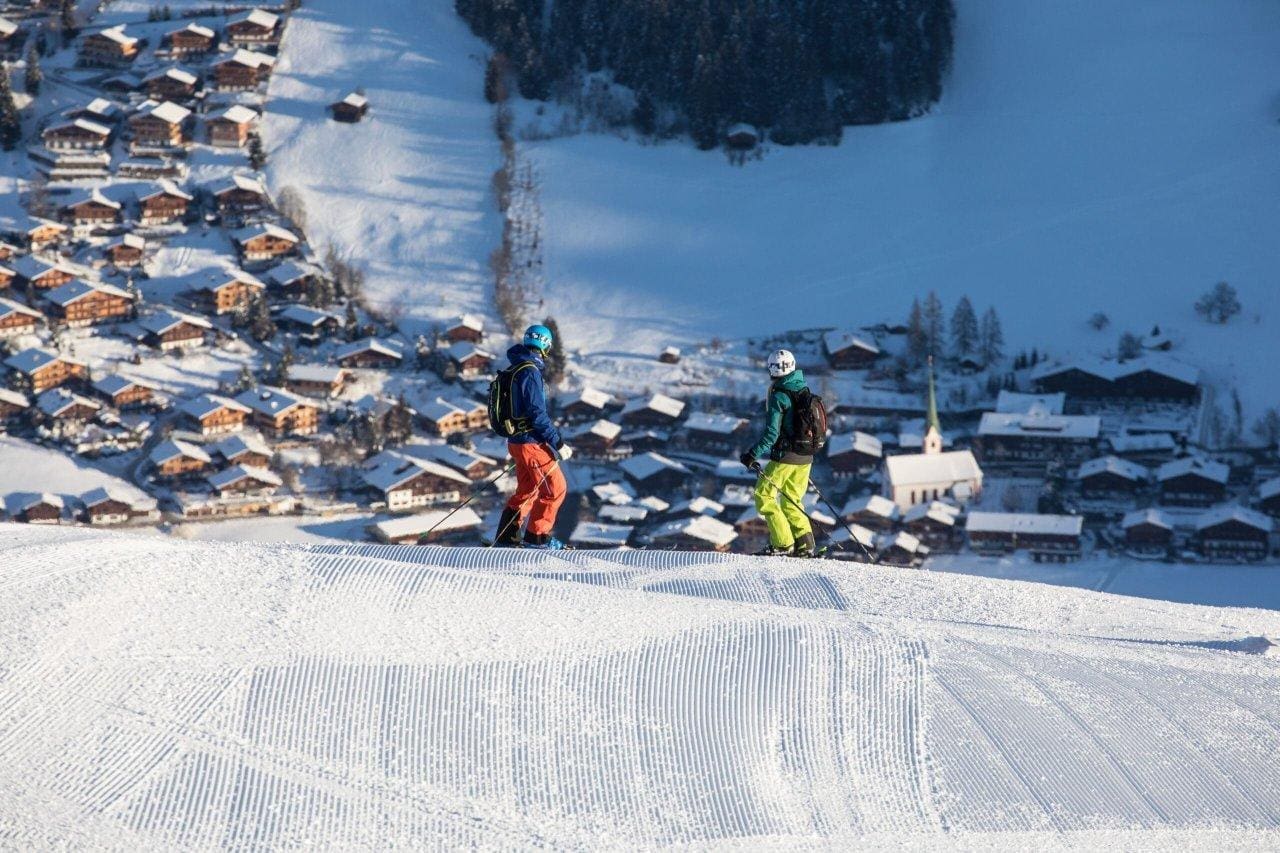 Ski Juwel Alpbachtal Wildschönau - Markbachjochbahn in Austria - a group of people skiing down a hill.