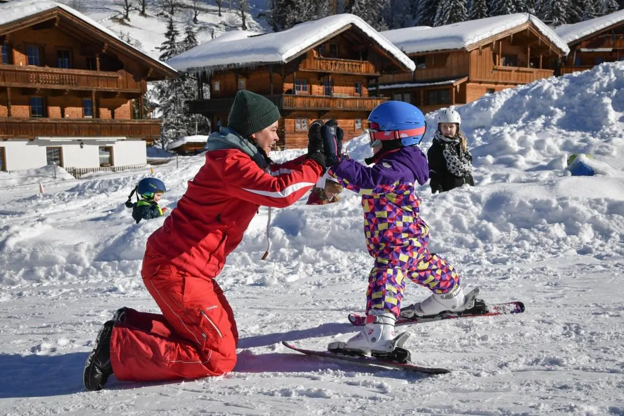 Ski Juwel Alpbachtal Wildschönau - Markbachjochbahn in Austria - two children playing in the snow with ski equipment.