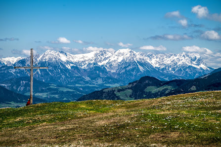 Spectacular view of Romme Alpin in Borlänge, Sweden. A sunny day illuminates the snow-coated mountain, chalet, and ski resort offering a serene winter landscape.