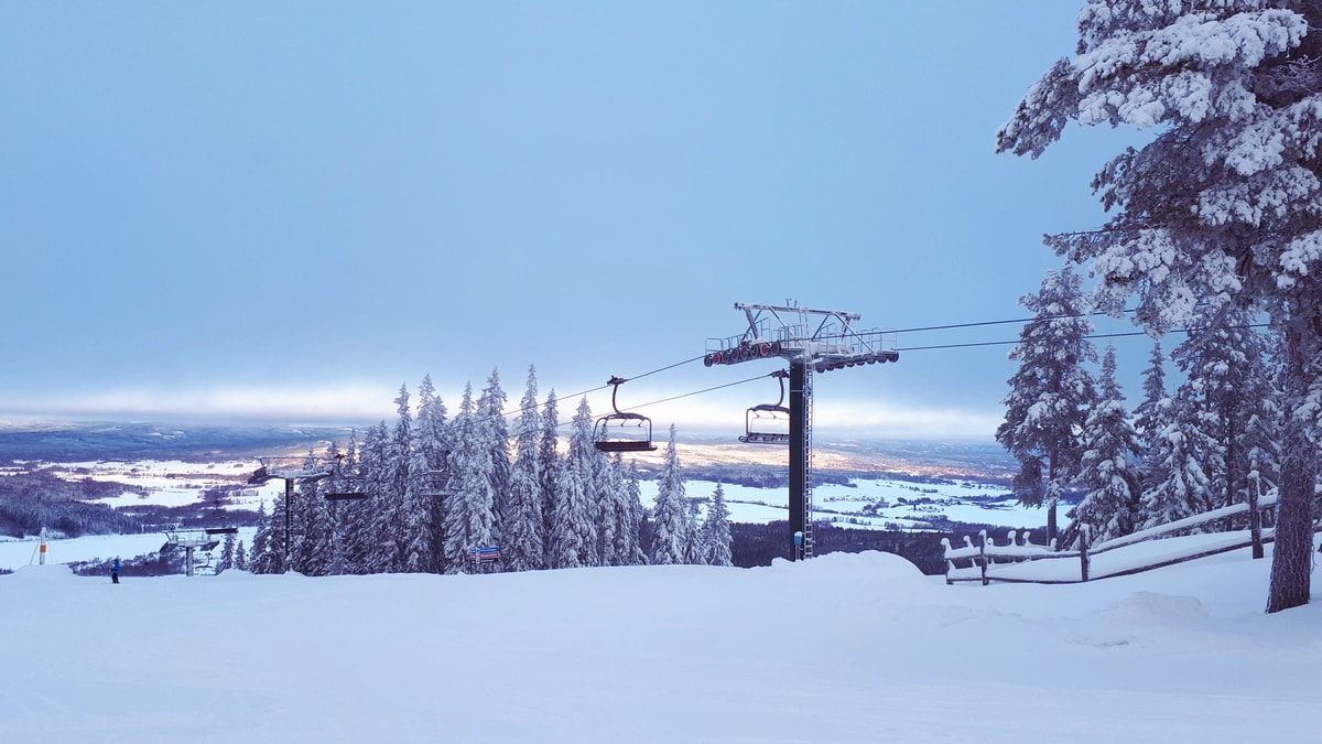 Romme Alpin in Sweden - a ski lift going up a snowy hill.