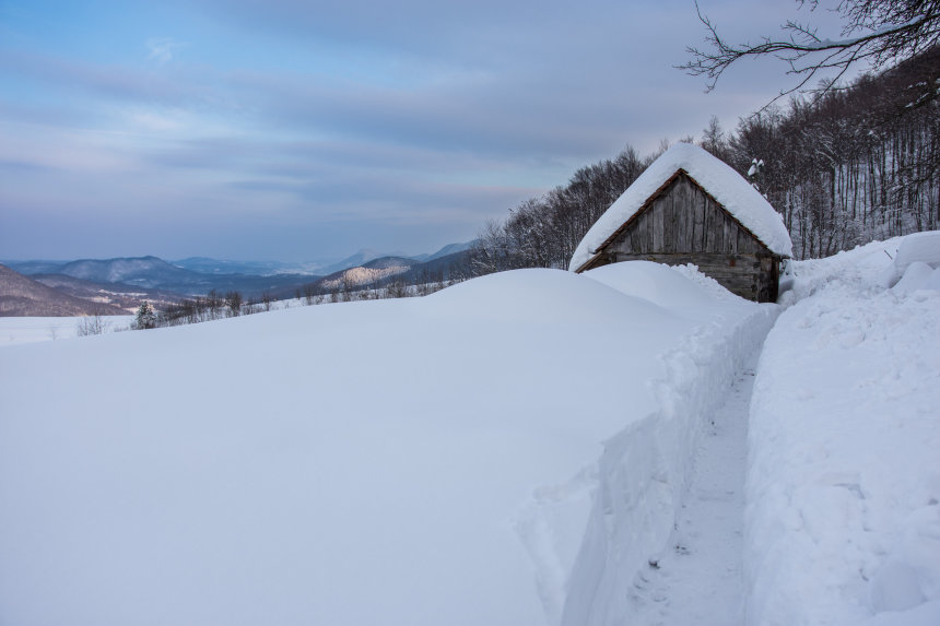 Skijalište Jarki in Croatia - a snow covered cabin sits on the side of a mountain.
