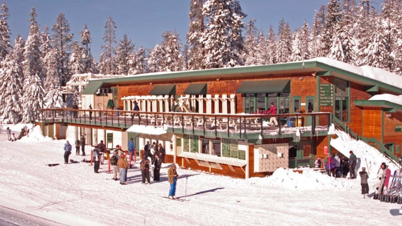 China Peak Mountain Resort in USA - a group of people standing outside of a ski lodge.