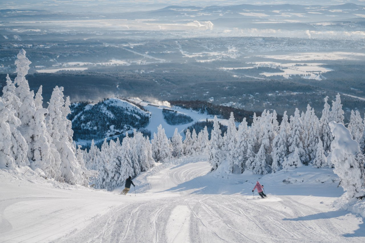 Mont-Orford in Canada - a person skiing down a snow covered mountain.
