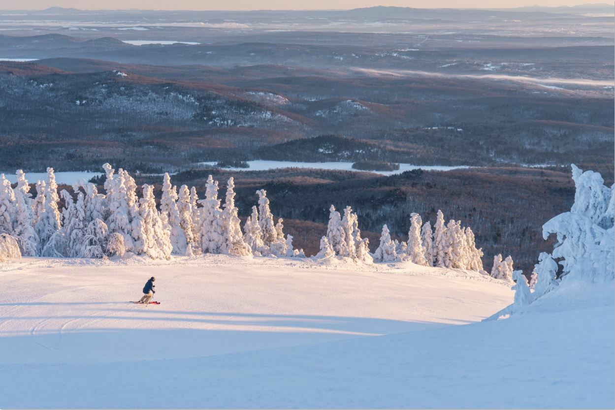 Mont-Orford in Canada - a person on a snowboard in the snow.