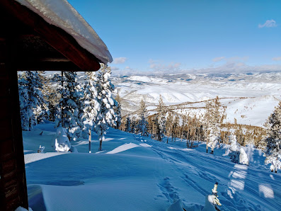 Winter landscape at Great Divide ski resort in Marysville, Montana, showcasing a stunning snowy scenery, active winter sports and a ski lift in the distance.