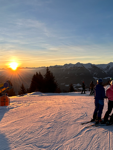 A family enjoying skiing at the popular Rosskopf – Sterzing ski resort in South Tyrol Italy. A beautiful winter scene unfolds with majestic mountains in the backdrop.