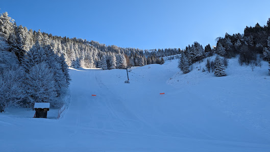 Winter sports scene at the Station Le Planolet in Saint Pierre de Chartreuse Isère France featuring a ski resort a charming chalet and a ski lift.