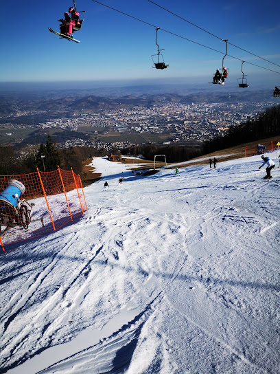 Image showcasing a winter sports scene at Shymbulak, Almaty, Kazakhstan. Features include a charming chalet, a skier in action, a ski lift and the overall atmosphere of a bustling ski resort.