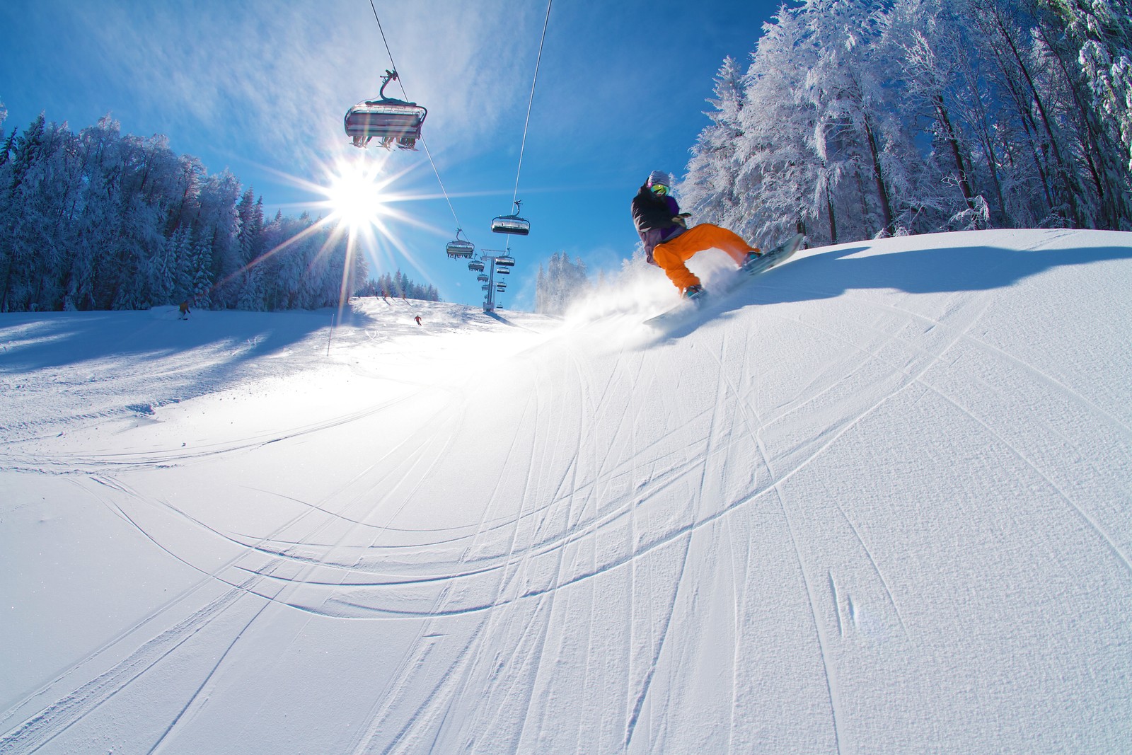 Mariborsko Pohorje in Slovenia - a man riding a snowboard down a snow covered slope.