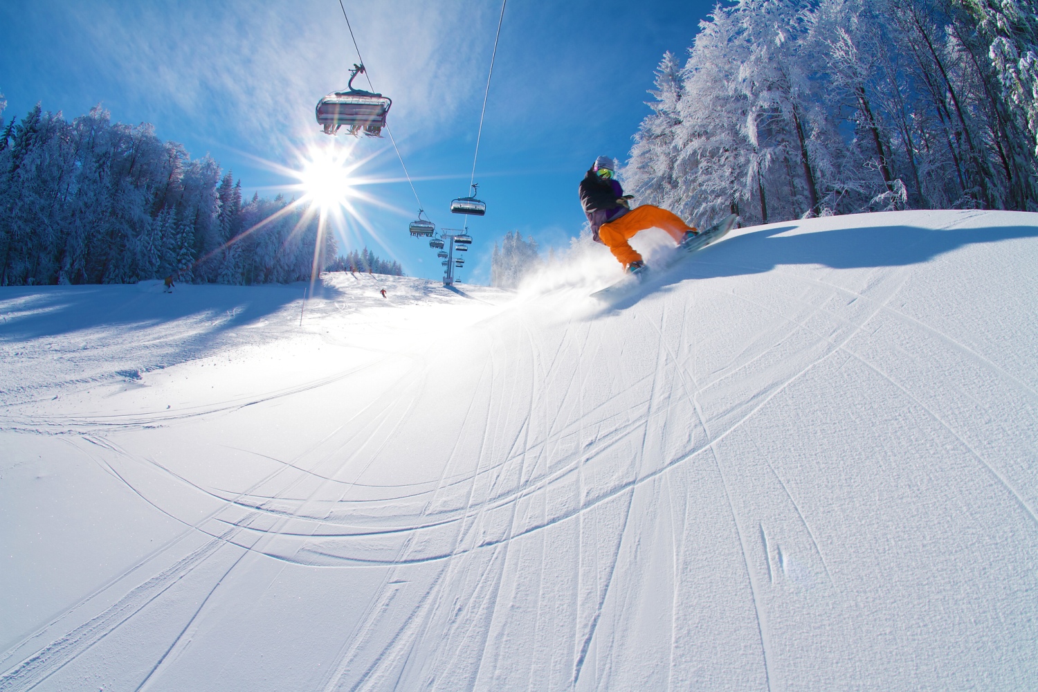 Mariborsko Pohorje in Slovenia - a person riding a snowboard down a snowy slope.