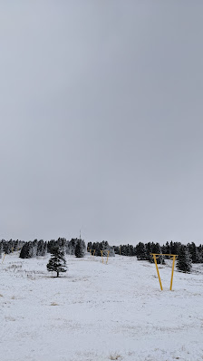 Winter scene at Uludag Ski Center in Turkey, showcasing a ski resort nestled amid snowy mountains. Ski lifts can be seen transporting adventurous skiers, contributing to a bustling winter sports ambiance.