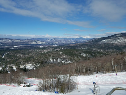 Ski resort in Monts Jura, France featuring a winter sports scene with a ski lift ascending the snow-covered slopes towards a quaint challet.