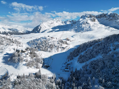 View of Cranmore Mountain Resort in New Hampshire, featuring a bustling ski resort with challet nestled amongst snow-covered slopes, capturing the essence of a winter sports scene and picturesque winter scenery.
