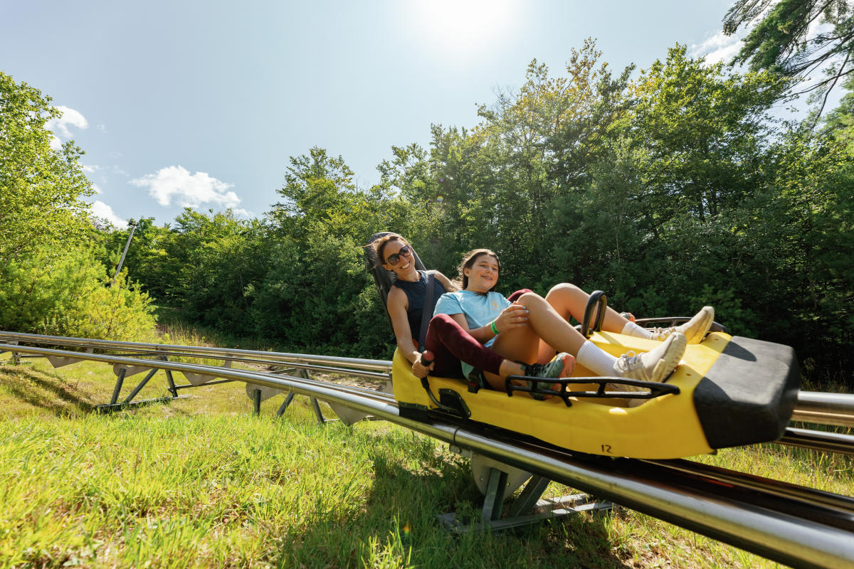 Cranmore Mountain Resort in USA - two people sitting on a roller coaster.