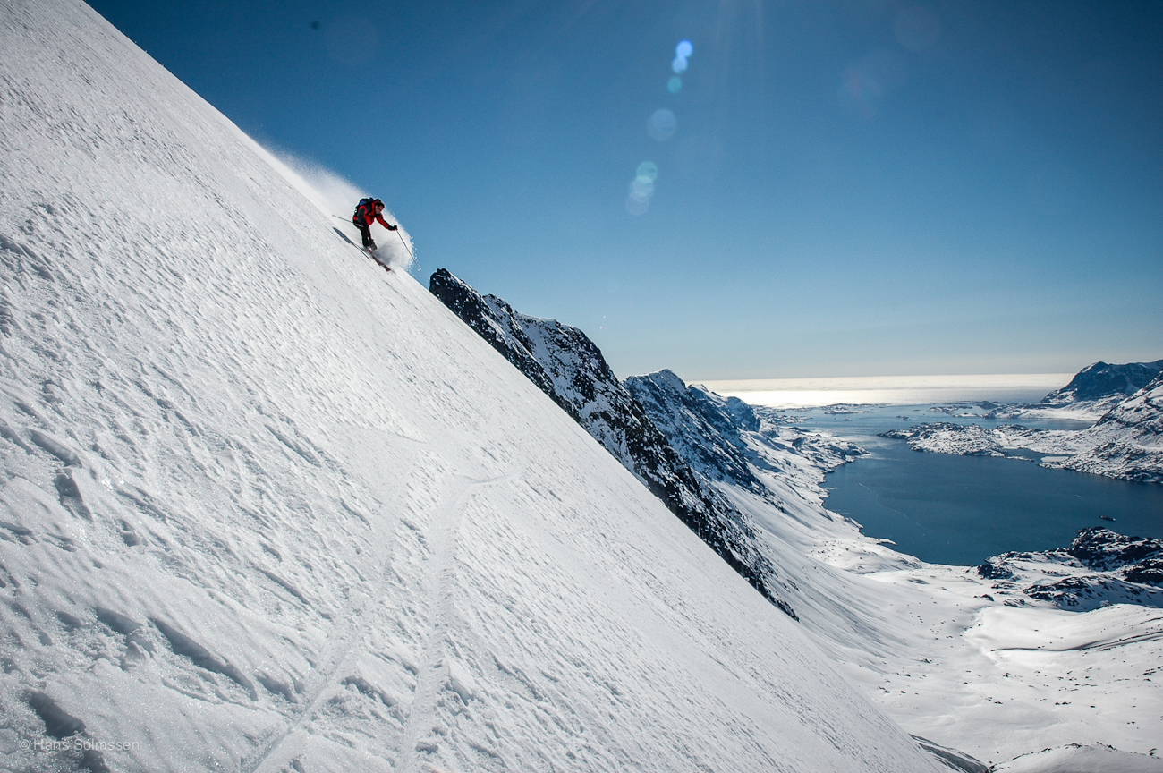 Disko Island in Greenland - a person on a snowboard on a snowy slope.